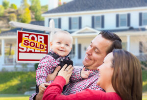 smiling baby and couple house for sale